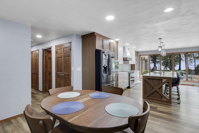 6500 E Decorah Ave, Oshkosh, WI 54902 - dining area featuring light wood-style floors, recessed lighting, and baseboards