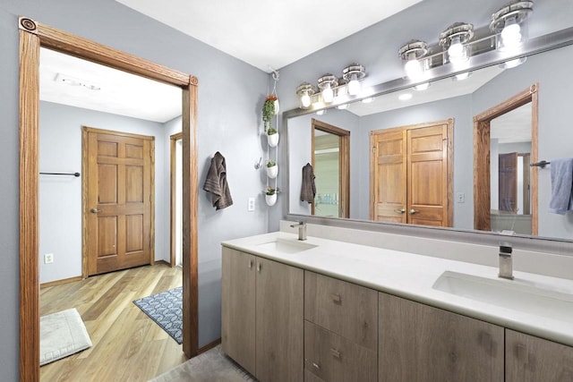 6500 E Decorah Ave, Oshkosh, WI 54902 - full bathroom with double vanity and wood finished floors
