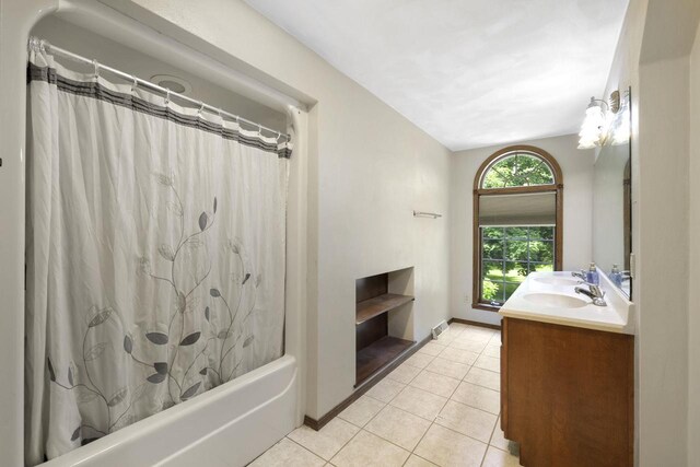 6500 E Decorah Ave, Oshkosh, WI 54902 - bathroom featuring double vanity, tile patterned flooring, shower / bath combo with shower curtain, and baseboards