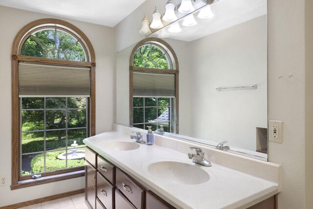 6500 E Decorah Ave, Oshkosh, WI 54902 - bathroom featuring double vanity, healthy amount of natural light, and tile patterned flooring
