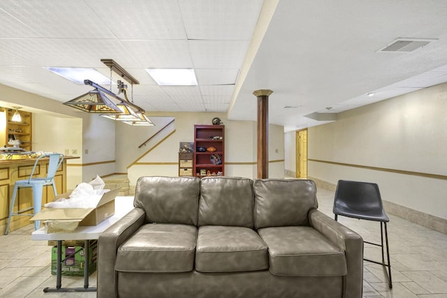 6500 E Decorah Ave, Oshkosh, WI 54902 - living area featuring a paneled ceiling and baseboards