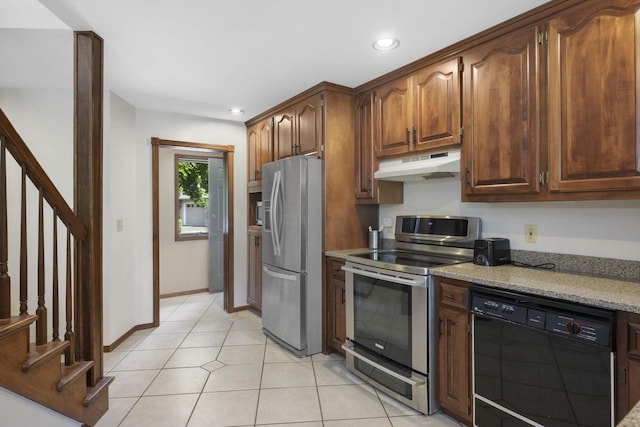 6500 E Decorah Ave, Oshkosh, WI 54902 - kitchen with stainless steel appliances, under cabinet range hood, recessed lighting, light tile patterned flooring, and light stone counters