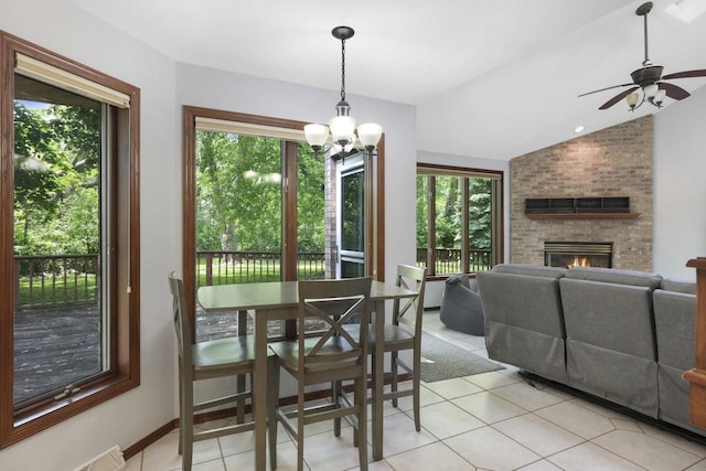 6500 E Decorah Ave, Oshkosh, WI 54902 - dining area with healthy amount of natural light, light tile patterned flooring, lofted ceiling, a brick fireplace, and ceiling fan