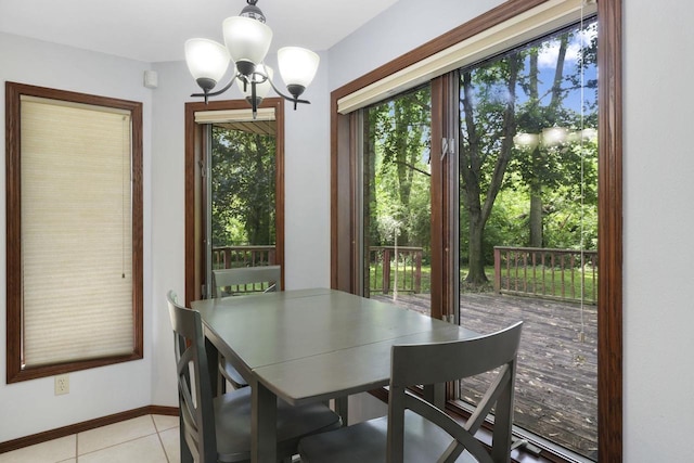 6500 E Decorah Ave, Oshkosh, WI 54902 - dining area with a chandelier, light tile patterned floors, and baseboards