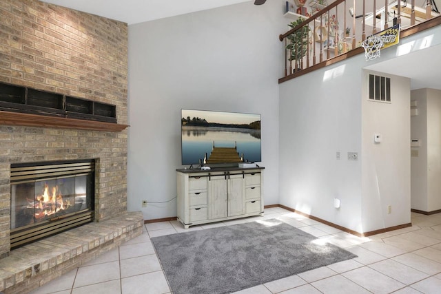 6500 E Decorah Ave, Oshkosh, WI 54902 - unfurnished living room with tile patterned flooring, a brick fireplace, baseboards, and a high ceiling