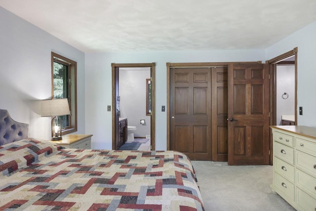 6500 E Decorah Ave, Oshkosh, WI 54902 - bedroom with light colored carpet, ensuite bath, and a closet
