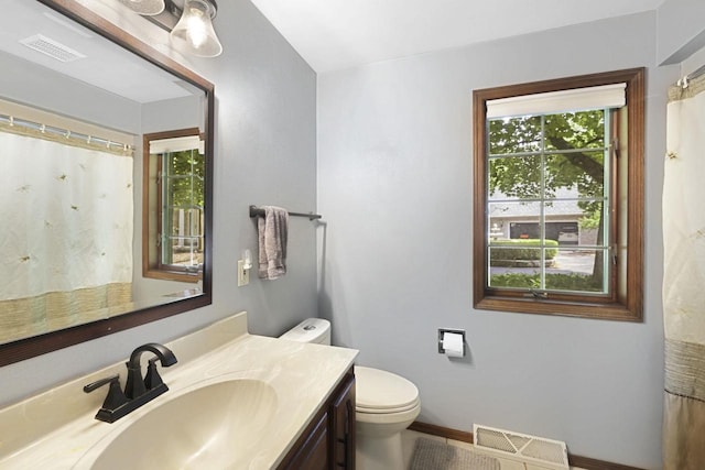 6500 E Decorah Ave, Oshkosh, WI 54902 - bathroom with vanity, toilet, and baseboards
