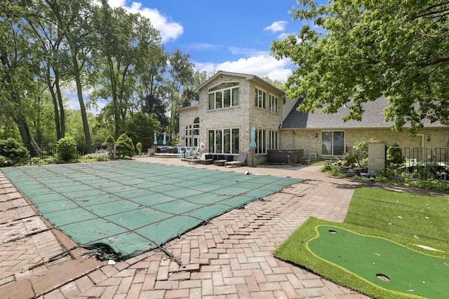 6500 E Decorah Ave, Oshkosh, WI 54902 - view of pool with a putting area, a patio, and a jacuzzi