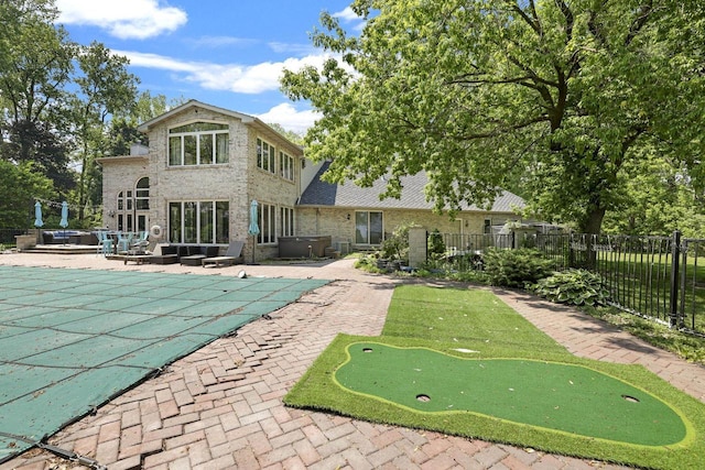6500 E Decorah Ave, Oshkosh, WI 54902 - view of swimming pool with a putting green, a patio, and a hot tub