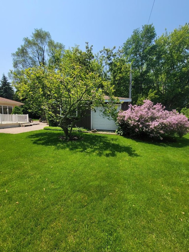 1406 E Oakwood Rd, Oak Creek, WI 53154 - view of grassy yard with a wooden deck and an outbuilding
