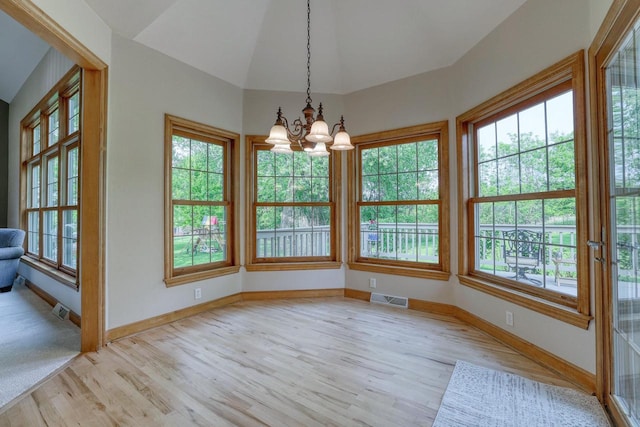 W287N4068 Highland Ct, Pewaukee, WI 53072 - unfurnished dining area featuring light wood-style flooring, a chandelier, baseboards, and vaulted ceiling