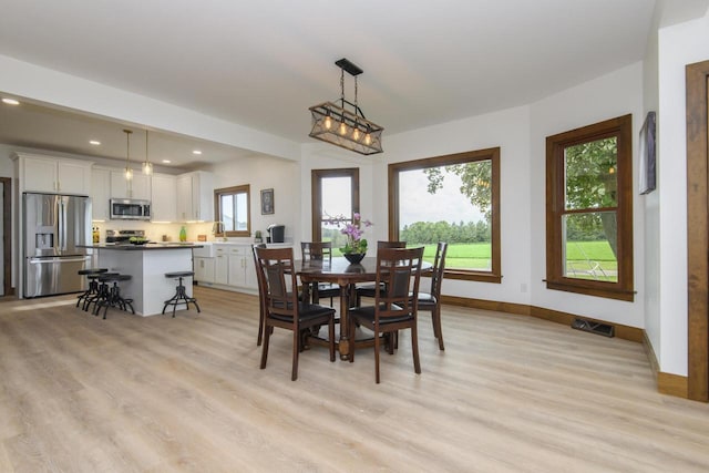W6497 Vandre Rd, Johnson Creek, WI 53038 - dining space featuring light wood-type flooring, baseboards, and recessed lighting