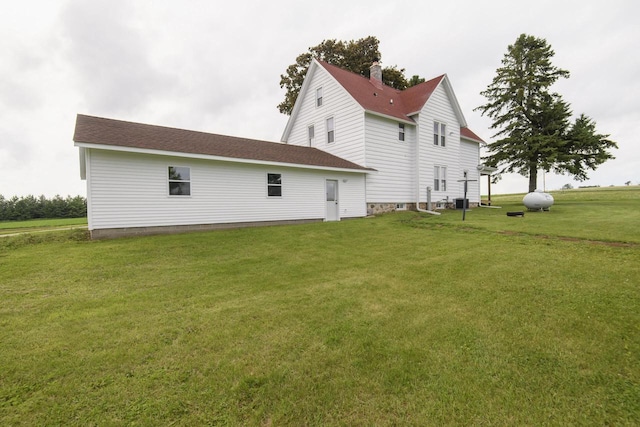 W6497 Vandre Rd, Johnson Creek, WI 53038 - view of side of home with a lawn and a chimney