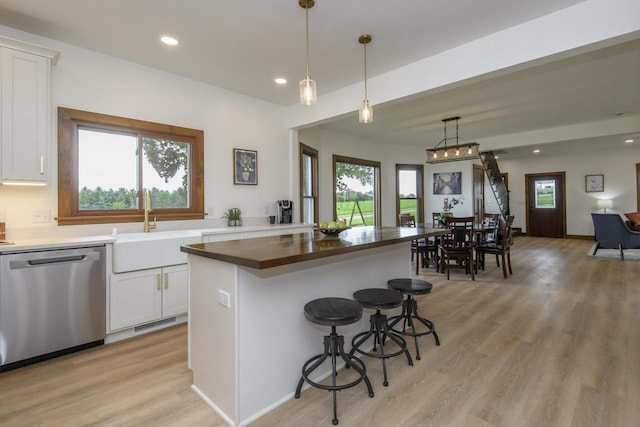 W6497 Vandre Rd, Johnson Creek, WI 53038 - kitchen with dishwasher, a sink, butcher block countertops, white cabinets, and recessed lighting