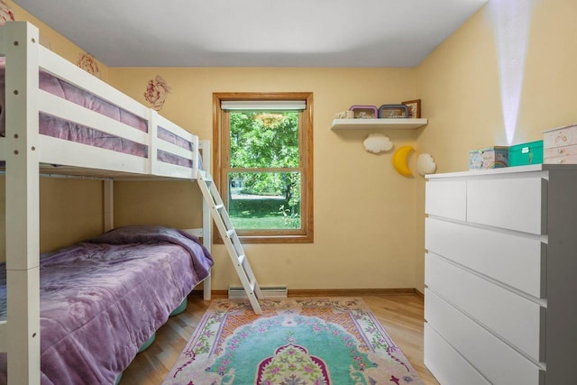 412 Frost Woods Rd, Monona, WI 53716 - bedroom featuring light wood finished floors and a baseboard radiator