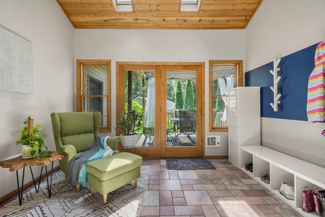 412 Frost Woods Rd, Monona, WI 53716 - living area featuring french doors, wood ceiling, a skylight, stone finish floors, and vaulted ceiling