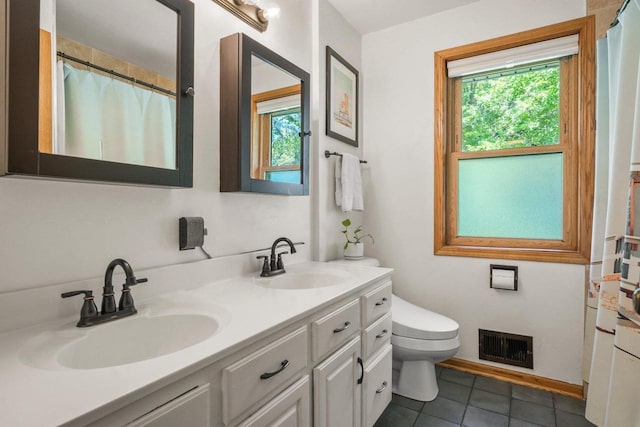 412 Frost Woods Rd, Monona, WI 53716 - bathroom featuring healthy amount of natural light, double vanity, tile patterned floors, and a shower with shower curtain