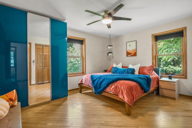 412 Frost Woods Rd, Monona, WI 53716 - bedroom with multiple windows, light wood-type flooring, and a ceiling fan
