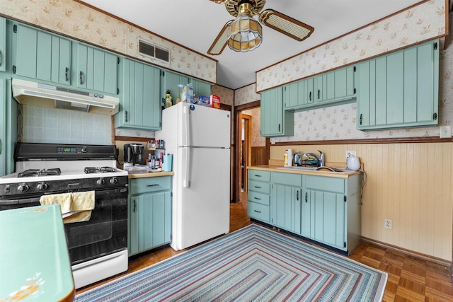 1472 S 86th St, West Allis, WI 53214 - kitchen with range with gas stovetop, freestanding refrigerator, under cabinet range hood, wallpapered walls, and ceiling fan