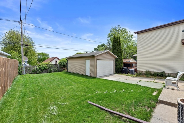1472 S 86th St, West Allis, WI 53214 - view of yard featuring a detached garage, an outdoor structure, and central AC unit