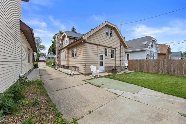 1472 S 86th St, West Allis, WI 53214 - back of property featuring a chimney, entry steps, and a patio area
