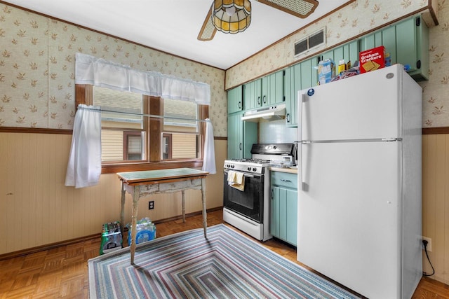 1472 S 86th St, West Allis, WI 53214 - kitchen featuring white appliances, under cabinet range hood, wallpapered walls, wainscoting, and green cabinetry