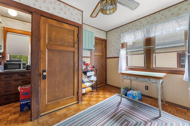 1472 S 86th St, West Allis, WI 53214 - entrance foyer featuring wallpapered walls, wainscoting, ceiling fan, baseboards, and wood walls