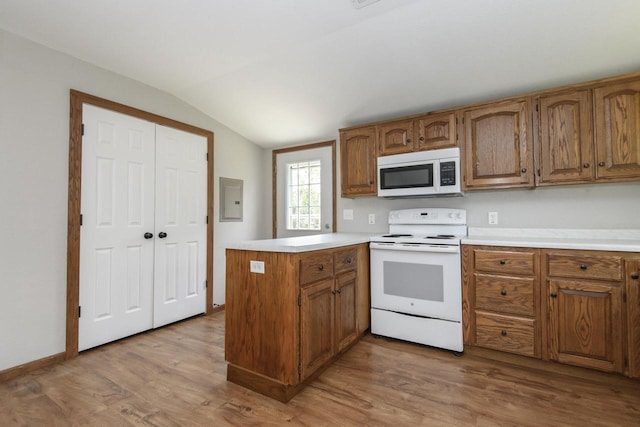 9219 Caddy Ln, Caledonia, WI 53108 - kitchen with white appliances, vaulted ceiling, a peninsula, brown cabinets, and wood finished floors