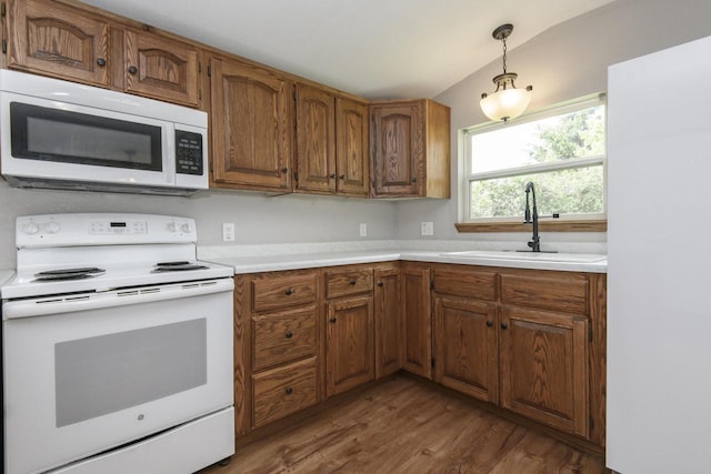 9219 Caddy Ln, Caledonia, WI 53108 - kitchen with white appliances, dark wood-style floors, light countertops, and brown cabinets