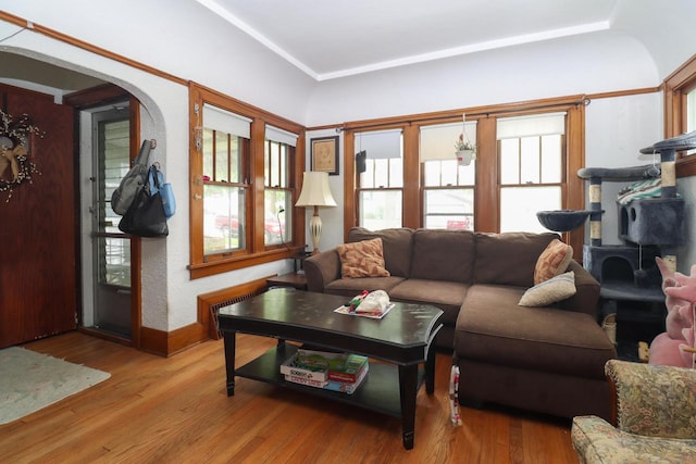 1711 S 85th St, Milwaukee, WI 53214 - living room featuring light wood-style floors, arched walkways, and baseboards
