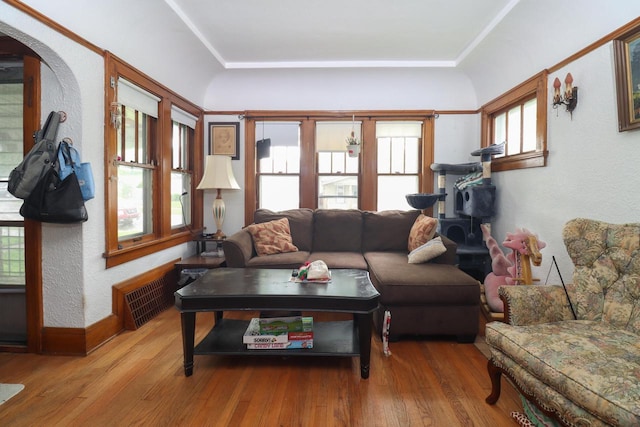1711 S 85th St, Milwaukee, WI 53214 - living area with wood-type flooring, a textured wall, baseboards, and arched walkways