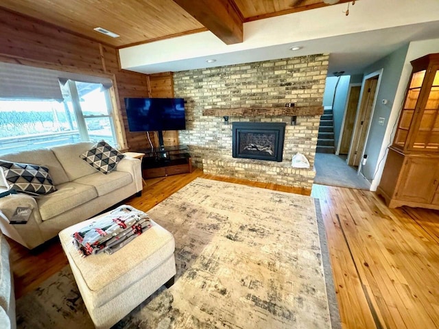 N8415 Branch Rd, Ixonia, WI 53036 - living area featuring hardwood / wood-style floors, wooden ceiling with exposed beams, and a fireplace