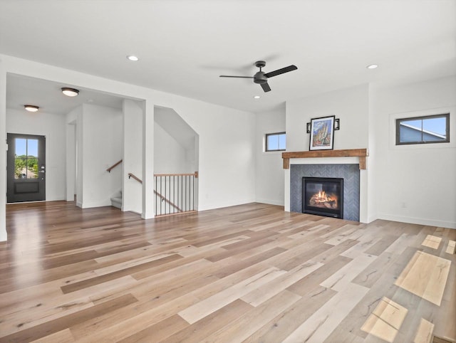 9437 Cobalt St, Middleton, WI 53562 - unfurnished living room with a fireplace, light wood-style floors, a ceiling fan, and recessed lighting