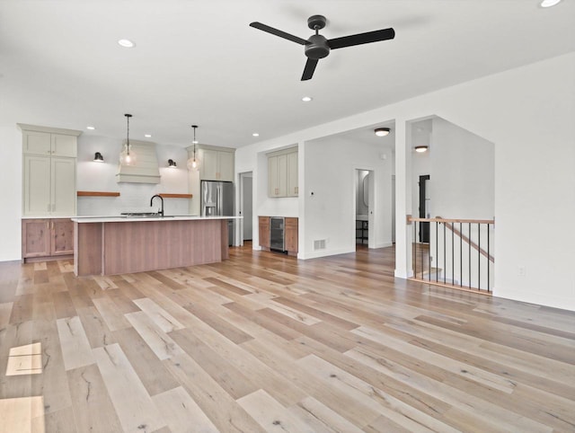 9437 Cobalt St, Middleton, WI 53562 - unfurnished living room with beverage cooler, recessed lighting, light wood-type flooring, and a ceiling fan