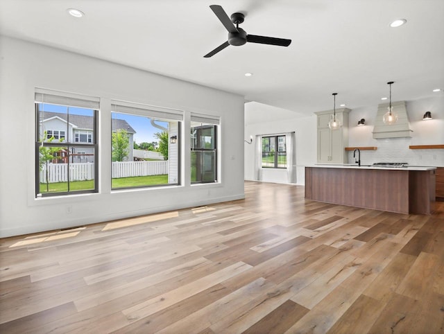 9437 Cobalt St, Middleton, WI 53562 - unfurnished living room featuring light wood-style floors, recessed lighting, and ceiling fan