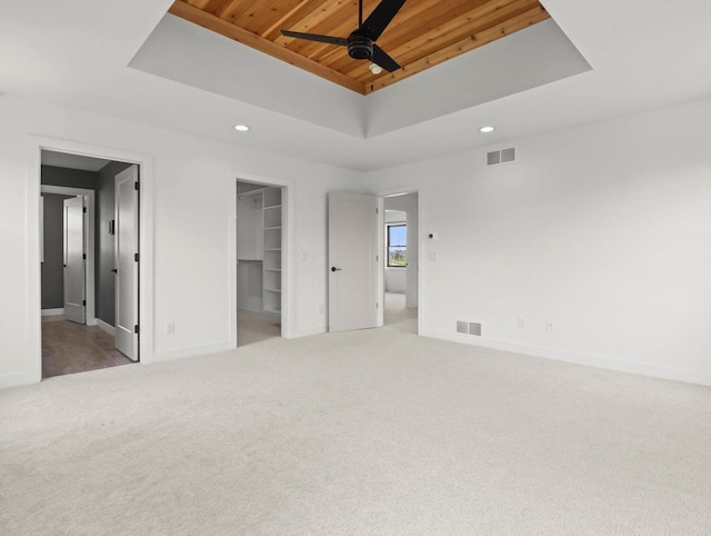9437 Cobalt St, Middleton, WI 53562 - unfurnished bedroom with a tray ceiling, recessed lighting, a spacious closet, wooden ceiling, and carpet