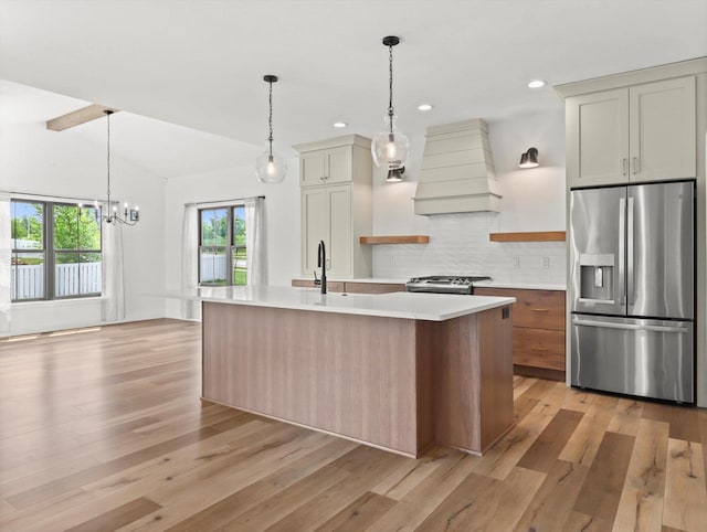 9437 Cobalt St, Middleton, WI 53562 - kitchen featuring appliances with stainless steel finishes, custom exhaust hood, light countertops, light wood-type flooring, and recessed lighting