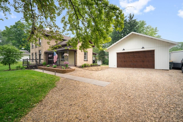 2205 Salisbury Rd, West Bend, WI 53090 - view of front of house featuring a garage, a front yard, and an outbuilding
