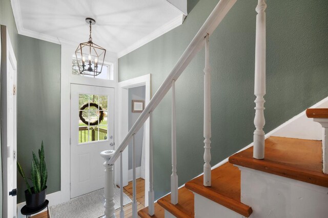 2205 Salisbury Rd, West Bend, WI 53090 - entrance foyer with stairway, a chandelier, crown molding, and wood finished floors