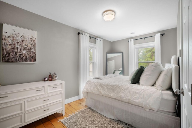 2205 Salisbury Rd, West Bend, WI 53090 - bedroom with light wood-type flooring and baseboards