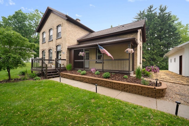 2205 Salisbury Rd, West Bend, WI 53090 - view of front of property featuring a front lawn, a porch, brick siding, a wooden deck, and a shingled roof