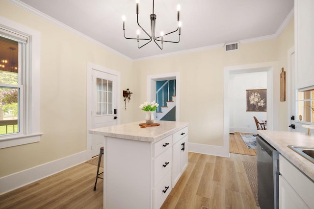 2205 Salisbury Rd, West Bend, WI 53090 - kitchen featuring stainless steel dishwasher, light wood-style flooring, a center island, white cabinets, and ornamental molding