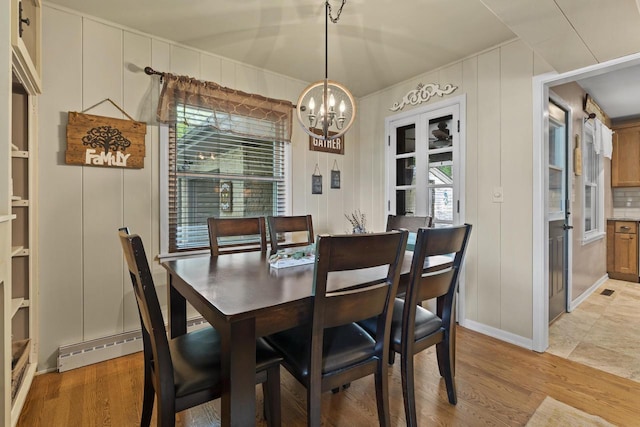 12554 Knoll Rd, Elm Grove, WI 53122 - dining area with a chandelier, light wood-type flooring, and a decorative wall