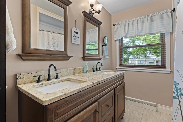 12554 Knoll Rd, Elm Grove, WI 53122 - bathroom featuring baseboard heating and double vanity