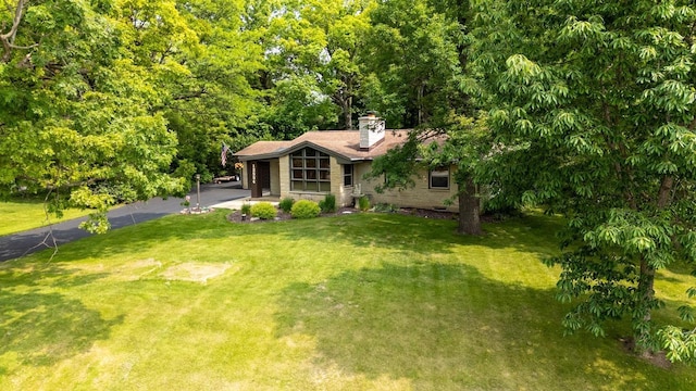 12554 Knoll Rd, Elm Grove, WI 53122 - view of front of house featuring driveway, a chimney, and a front lawn