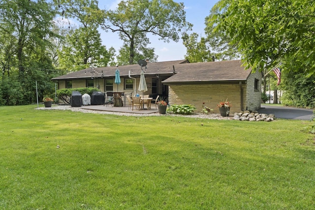 12554 Knoll Rd, Elm Grove, WI 53122 - back of property featuring stone siding, a patio, and a yard