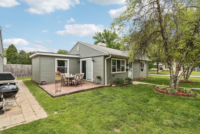 3036 S 65th Ct, Milwaukee, WI 53219 - back of house featuring a patio and a chimney