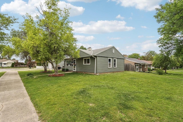 3036 S 65th Ct, Milwaukee, WI 53219 - view of home's exterior featuring a lawn and a chimney