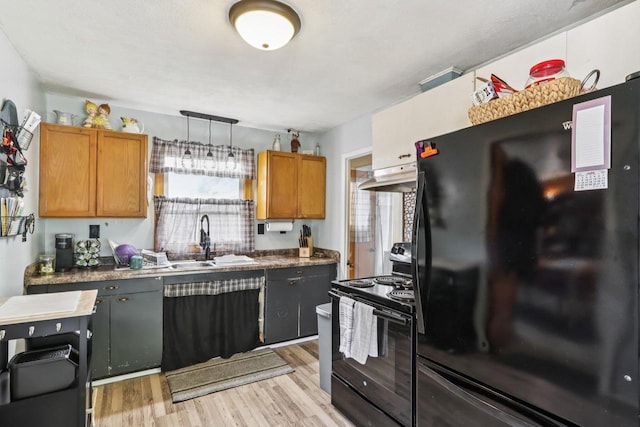 3036 S 65th Ct, Milwaukee, WI 53219 - kitchen with black appliances, a sink, light wood-style floors, and under cabinet range hood