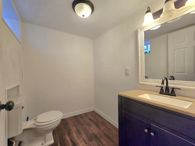 9829 W Lincoln Ave, West Allis, WI 53227 - bathroom with wood finished floors, vanity, toilet, and baseboards
